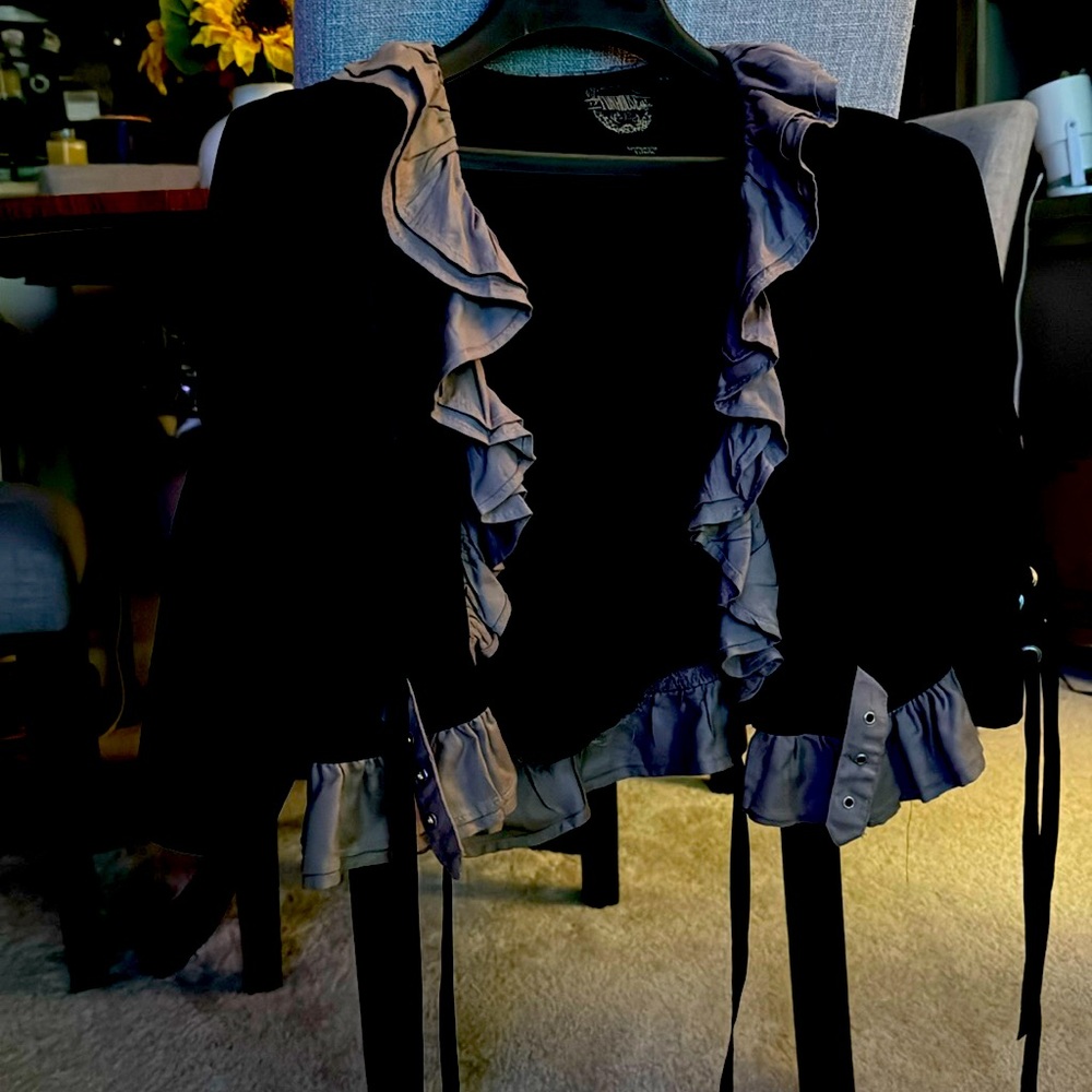 This is a jacket with laces and ruffles in the back and front.